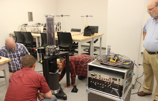 scientists working with gravimeter